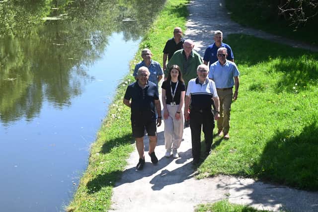 Local councillors and representatives of Community Payback and the Canal and River Trust walk along the improved towpath between New Springs and Haigh Woodland Park