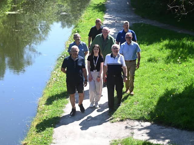 Local councillors and representatives of Community Payback and the Canal and River Trust walk along the improved towpath between New Springs and Haigh Woodland Park