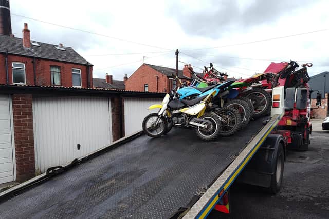 The suspected stolen off-road bikes seized from an address in Peter Street, Leigh, are put on a low-loader