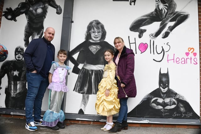 Holly Prince's family see the mural for the first time - dad Mark, brother Jack, nine, sister Evie, 11, and mum Jenny