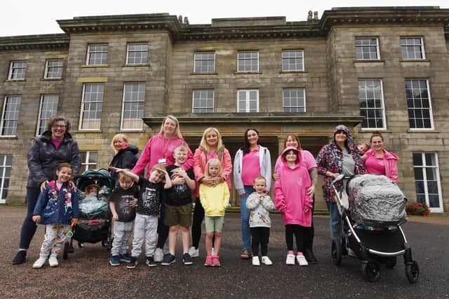 Parents and children do a sponsored walk at Haigh Woodland Park to raise £750 for 50 home visits to mums in the Wigan borough