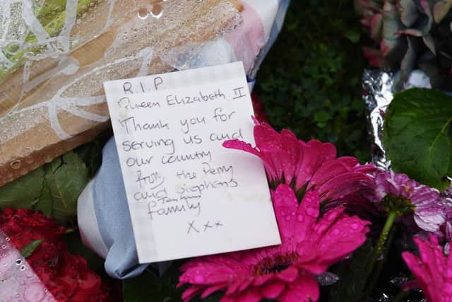 Flowers left in memory and tribute to HRH Queen Elizabeth II outside Wigan Parish Church.