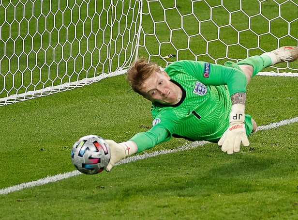 England's goalkeeper Jordan Pickford saves a penalty during the UEFA EURO 2020 final football match between Italy and England at the Wembley Stadium in London on July 11, 2021. (Photo by JOHN SIBLEY / POOL / AFP) (Photo by JOHN SIBLEY/POOL/AFP via Getty Images)