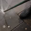 A council worker using an Aqua Fortis, or "Gumbuster", in a bid to remove chewing gum from roads and pavements