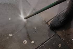 A council worker using an Aqua Fortis, or "Gumbuster", in a bid to remove chewing gum from roads and pavements