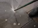 A council worker using an Aqua Fortis, or "Gumbuster", in a bid to remove chewing gum from roads and pavements