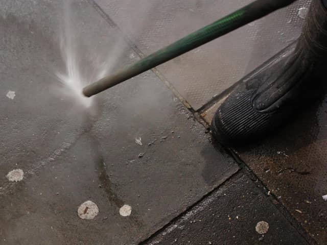 A council worker using an Aqua Fortis, or "Gumbuster", in a bid to remove chewing gum from roads and pavements