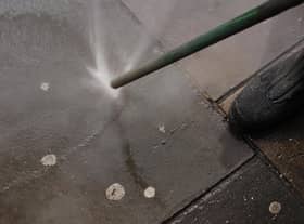 A council worker using an Aqua Fortis, or "Gumbuster", in a bid to remove chewing gum from roads and pavements
