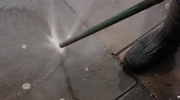 A council worker using an Aqua Fortis, or "Gumbuster", in a bid to remove chewing gum from roads and pavements