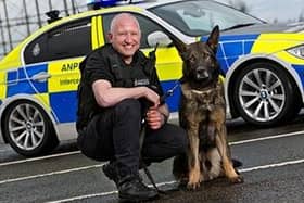 Portrait of PC Mark Richardson with his police dog Mo.