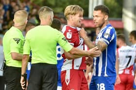 Josh Magennis received one of a dozen yellow cards issued to the visitors at Stevenage