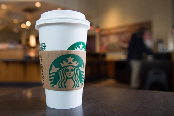 A Starbucks coffee cup (Photo by SAUL LOEB/AFP via Getty Images)