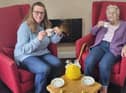 Anne Calland (right) visits B's Cafe at Belong Atherton for a chat with Admiral Nurse, Bridget Lawler (left)