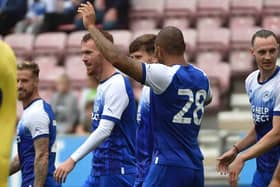 The Latics players celebrate Tom Naylor's goal