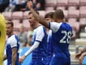 The Latics players celebrate Tom Naylor's goal