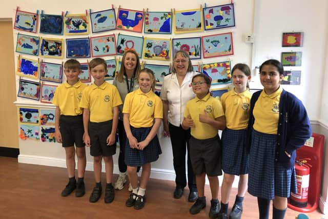 Elaine Rogers, Mrs Sedman and pupils from Nicol Mere Primary School with their artwork