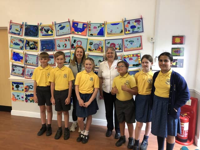 Elaine Rogers, Mrs Sedman and pupils from Nicol Mere Primary School with their artwork
