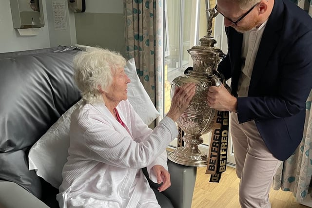 James Winterbottom, from Wigan Council, shows the Challenge Cup trophy to a hospice patient