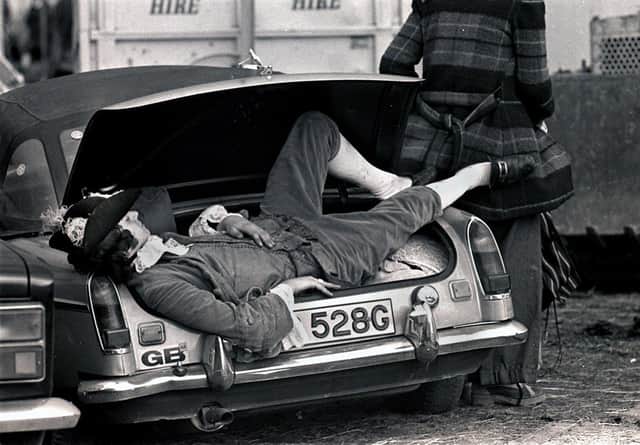 A dandy of a music fan takes a snooze in his car boot at the Bickershaw Festival in 1972.