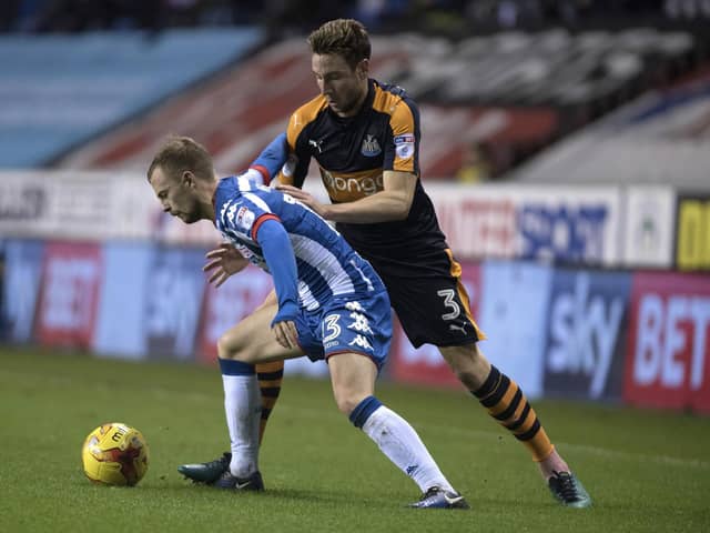 Paul Dummett (right) challenges Latics' Andy Kellett during Newcastle's visit in December 2016