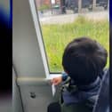 Little chap holds his ticket on route to Wigan