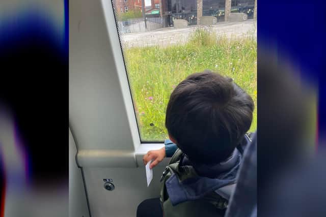 Little chap holds his ticket on route to Wigan