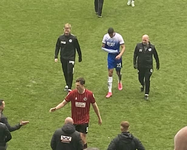Ashley Fletcher leaves the field for the last time as a Latics player, after breaking his arm against Millwall