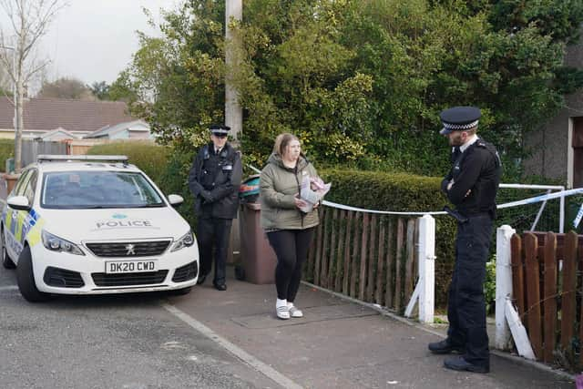 A woman lays flowers at a house in St Helens after a 17-month-old girl died after being attacked by a dog. Merseyside Police said officers received a report at 3.50pm on Monday that a child had been attacked by a dog at an address on Bidston Avenue, Blackbrook.