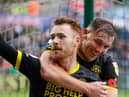 Tom Naylor celebrates doubling the Latics lead at Swansea