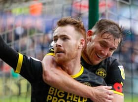 Tom Naylor celebrates doubling the Latics lead at Swansea
