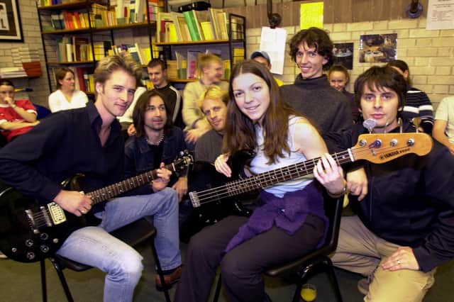 Rock singer and musician, Chesney Hawkes, left, and members of his band Manna with student, Amanda Taylor, during a music workshop at St. John Rigby College on Thursday 2nd of November 2000. 