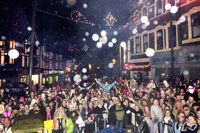 2004 - Some of the 7,000 people in Wigan Market Place to watch McFly turn on the Christmas lights and perform on stage in 2004.