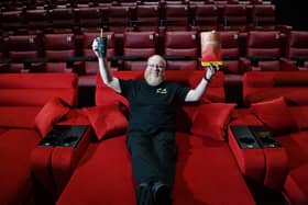 Supervisor Ross Aitchison demonstrates the comfy sofa seats in one of the  Maxx screens.