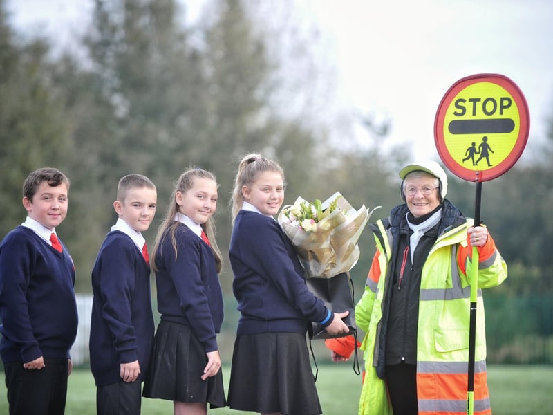 Dorothy Hawthorn is presented with a memento for years working as the school's lollipop lady at Westfield Primary School, Wigan