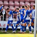 Jason Kerr gets the congratulations from his colleagues after opening the scoring