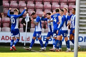 Jason Kerr gets the congratulations from his colleagues after opening the scoring