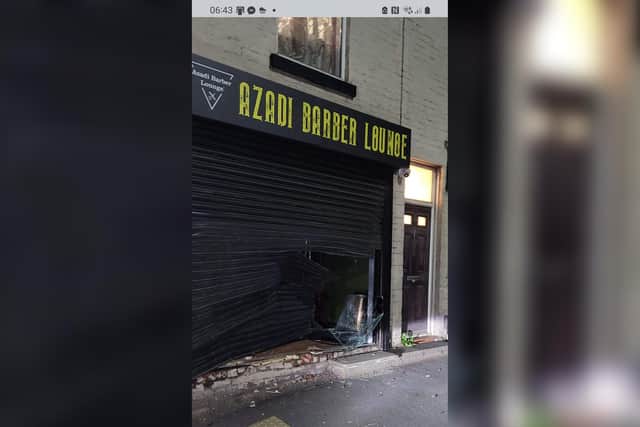 The van attack caused extensive damage to the front of the barbershop