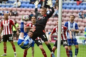 Joe Whitworth kept a clean sheet for Gary Caldwell's Exeter in a goalless draw at Wigan in 2024/5
