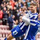 Scott Smith gets a pick-me-up rom Stephen Humphrys after his winning goal against Blackpool