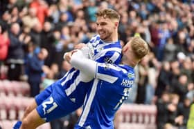 Scott Smith gets a pick-me-up rom Stephen Humphrys after his winning goal against Blackpool