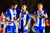 Goalscorer Dale Taylor (centre) is congratulated by James Carragher (left) and Jason Kerr (right)