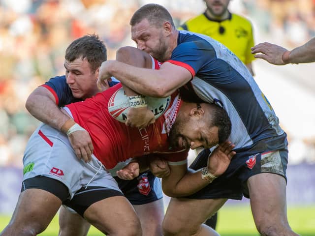 Tonga's Siliva Havili is tackled by England's Elliott Whitehead and Harry Smith