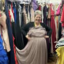 Daffodils Dreams volunteer Marie Pocock shows off the store's wide range of prom clothing.