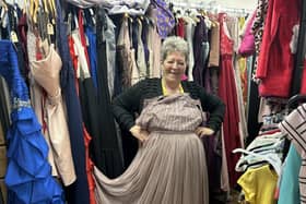 Daffodils Dreams volunteer Marie Pocock shows off the store's wide range of prom clothing.