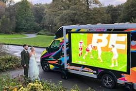 Tom and Gemma watch the Grand Final on the big screen on their wedding day