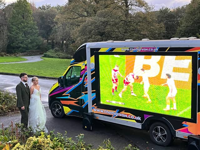 Tom and Gemma watch the Grand Final on the big screen on their wedding day