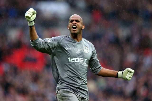 Goalkeeper Ali Al Habsi of Wigan Athletic celebrates after teammate Shaun Maloney scores the opening goal during the FA Cup with Budweiser Semi Final match between Millwall and Wigan Athletic at Wembley Stadium on April 13, 2013 in London, England.