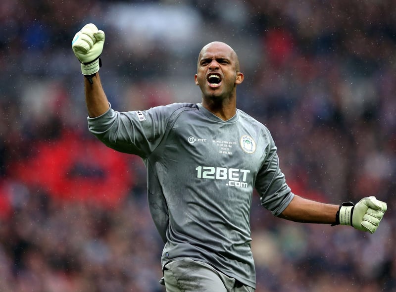 Goalkeeper Ali Al Habsi of Wigan Athletic celebrates after teammate Shaun Maloney scores the opening goal during the FA Cup with Budweiser Semi Final match between Millwall and Wigan Athletic at Wembley Stadium on April 13, 2013 in London, England.