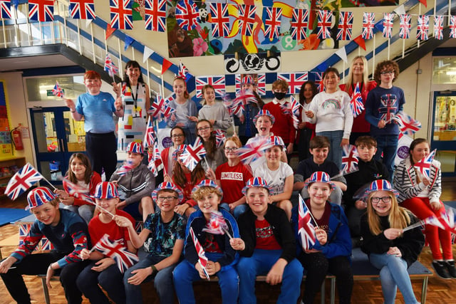 Pupils dress in red, white and blue, surrounded by union flags and bunting, as children sang songs from the 1950s to the 2020s  to celebrate the Queen's platinum jubilee - this was the first opportunity to bring school and local community together since the pandemic at Billinge Chapel End Primary School.