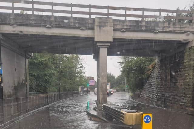 The road underneath the bridge on Southgate, in Wigan, has flooded